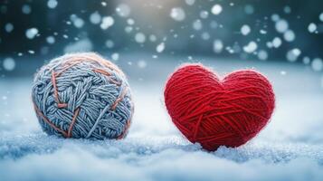 Two red hearts and yarn balls on a snowy background photo