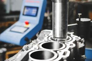 Repair and elimination of engine score. Service Boring under the piston after engine sleeve using machine with Computer Numerical Control. Engine cylinder boring on cnc machine. photo
