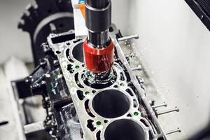 Diamond honing of engine on CNC machine. Cylinder boring engine machine. photo