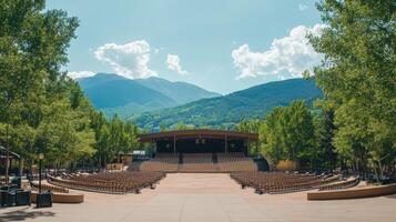 A stage surrounded by trees and mountains photo