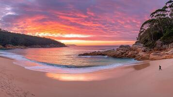 A beautiful sunset over the ocean and sand photo