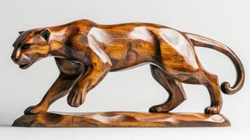 A wooden sculpture of a panther on a rock photo