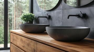 Two black bowls sit on a wooden counter top photo