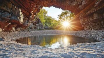 Sunrise in a cave with water and rocks photo