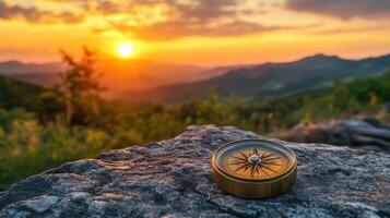 A compass on a rock at sunset photo