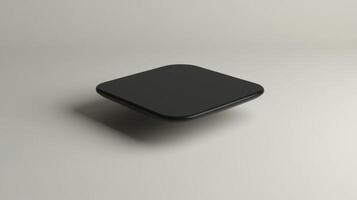 A black square object sitting on top of a white surface photo