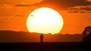 A person standing in front of a large sun photo