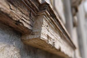 Weathered stonework corner captured in close-up, highlighting fine details and textures in the material. The shallow depth of field keeps the focus on the architecture's aged character photo