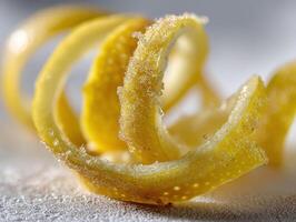 Curled citrus peel with visible sugar crystals glistens attractively under soft lighting, showcasing its textured and slightly translucent surface in an artistic and close-up composition photo