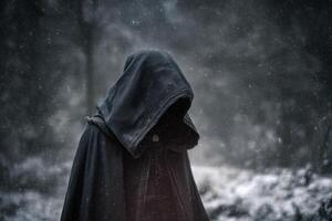 Dark hooded figure stands in snowy forest, cloaked in mysterious shadows, creating an eerie and atmospheric scene. Snowflakes gently fall, blurring the background, adding depth photo