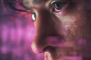 Close-up of a person's face with focus on the eye and nose, surrounded by abstract pink and purple digital effects, creating a futuristic and tech-inspired atmosphere photo