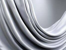 Draped silver fabric with glossy, smooth texture forming elegant folds and waves. The fabric's soft sheen and fluid motion create a luxurious and sophisticated appearance photo