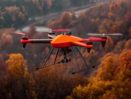 Orange drone with a camera flying over an autumn forest with colorful trees. The drone is prominently positioned, capturing vibrant fall foliage in the background with its four propellers photo