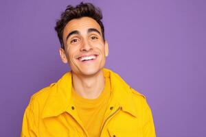 Smiling person in a bright yellow jacket stands against a purple background. The individual exudes a cheerful and upbeat demeanor, making the overall atmosphere feel warm and inviting photo