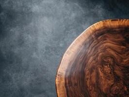 Close-up of a round wooden table with distinctive grain patterns on the top right corner against an undefined background, highlighting natural textures and craftsmanship photo