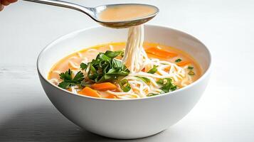 A spoon being lifted from a bowl of soup photo