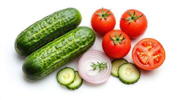 Fresh vegetables, cucumbers, tomatoes and onions on white background photo