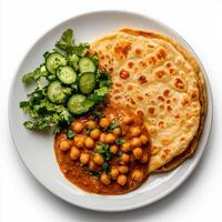 Chickpea curry with pita bread and cucumber photo