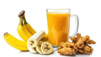 A glass of orange juice next to a bowl of fried chicken photo