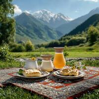 A table with a plate of food and a glass of juice photo