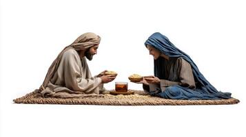 Two people sitting on the ground with food photo