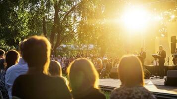 A crowd of people watching a concert at sunset photo