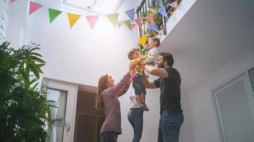 A family is standing in a room with colorful bunting photo
