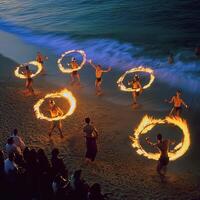 A group of people performing a fire dance on a beach photo