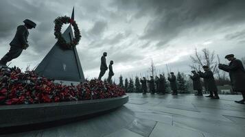 A group of people standing around a monument with a wreath photo