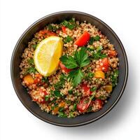 Crispy quinoa salad with lemon and parsley, isolated on white background photo