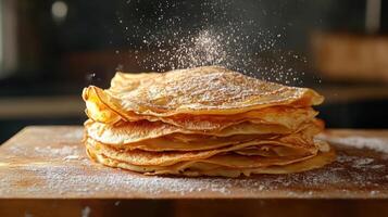 Stack of pancakes dusted with powdered sugar. photo