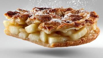 Delicious apple pie slice with flaky crust and powdered sugar. photo