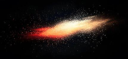An explosion of red and gold colored powder particles traverses a dark canvas photo