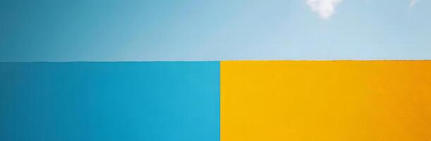 Bright blue sky meets vibrant yellow textured wall creating a modern abstract color block photo