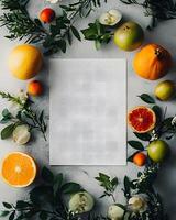 Flat lay showcases fresh fruit arrangement around textured paper against a subtle concrete backdrop photo