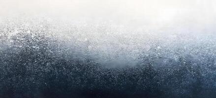 Frozen condensation covers the glass pane, fading from white at the top to deep blue at the bottom photo