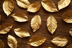 Glistening golden foliage elegantly rests upon a rich, rustic wooden surface creating a luxurious texture photo