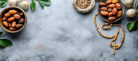 Golden rosary rests near dates and nuts, complementing the Islamic religious observance on a textured table photo