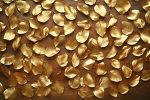 Golden shimmering leaves are gracefully scattered on a rich, textured wooden surface photo