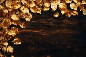 Golden shimmering leaves create a luxurious border over a dark rustic wooden background photo