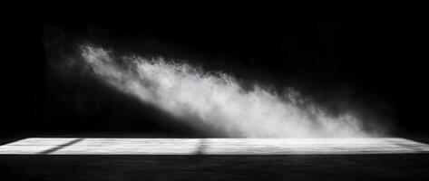 In a dark room, a cloud of white dust falls diagonally photo