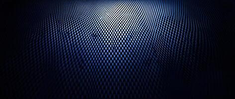 Light highlights a dark blue textured surface with a pattern of repeating oval shapes photo
