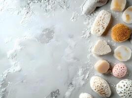Natural pumice stones and soap bar sit on a powdercovered grey surface creating spa ambiance photo
