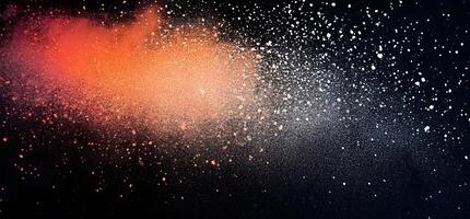 Orange and white powder explodes against a black canvas, creating a dynamic abstract effect photo