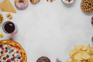 Overhead reveals various snacks and treats displayed artistically against a clean, white backdrop photo