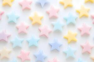 Pastel stars of pink, blue, and yellow create an aesthetic background on white photo