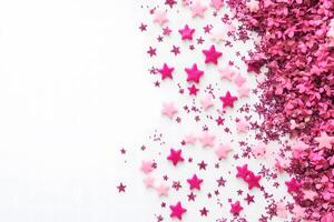 Pink confetti and star shapes are scattered across the white background, a festive celebration photo
