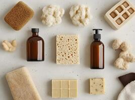 Spa sponges and amber pump bottles neatly arrange with natural handmade soaps on gray background photo