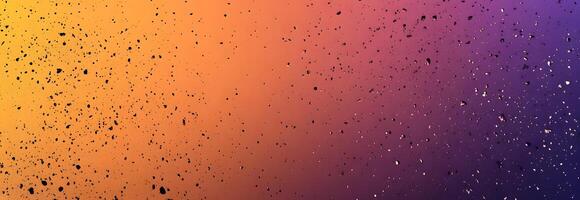 Splattered droplets create an abstract pattern transitioning between warm orange hues and cool purple tones effectively photo