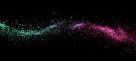 Turquoise slowly merges to purple powder across the dark canvas, creating a mesmerizing celestial effect photo